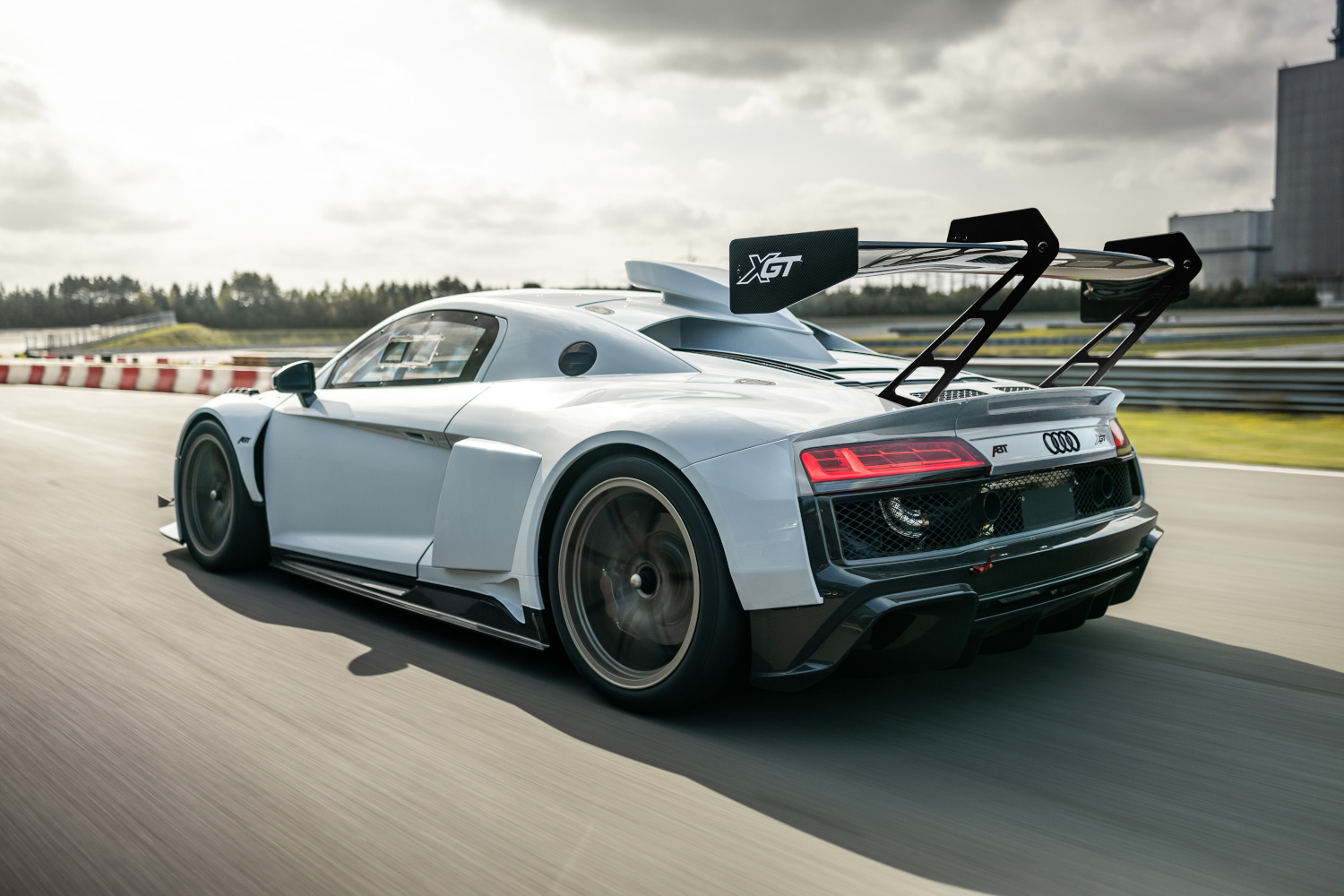 Black and white XGT from the side rear view when driving on the racetrack