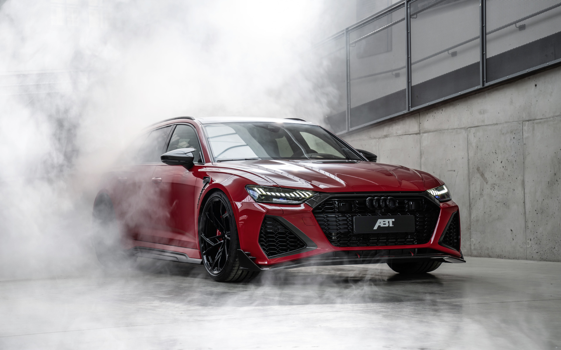 Red RS6-LE from the side front view in hall with fog