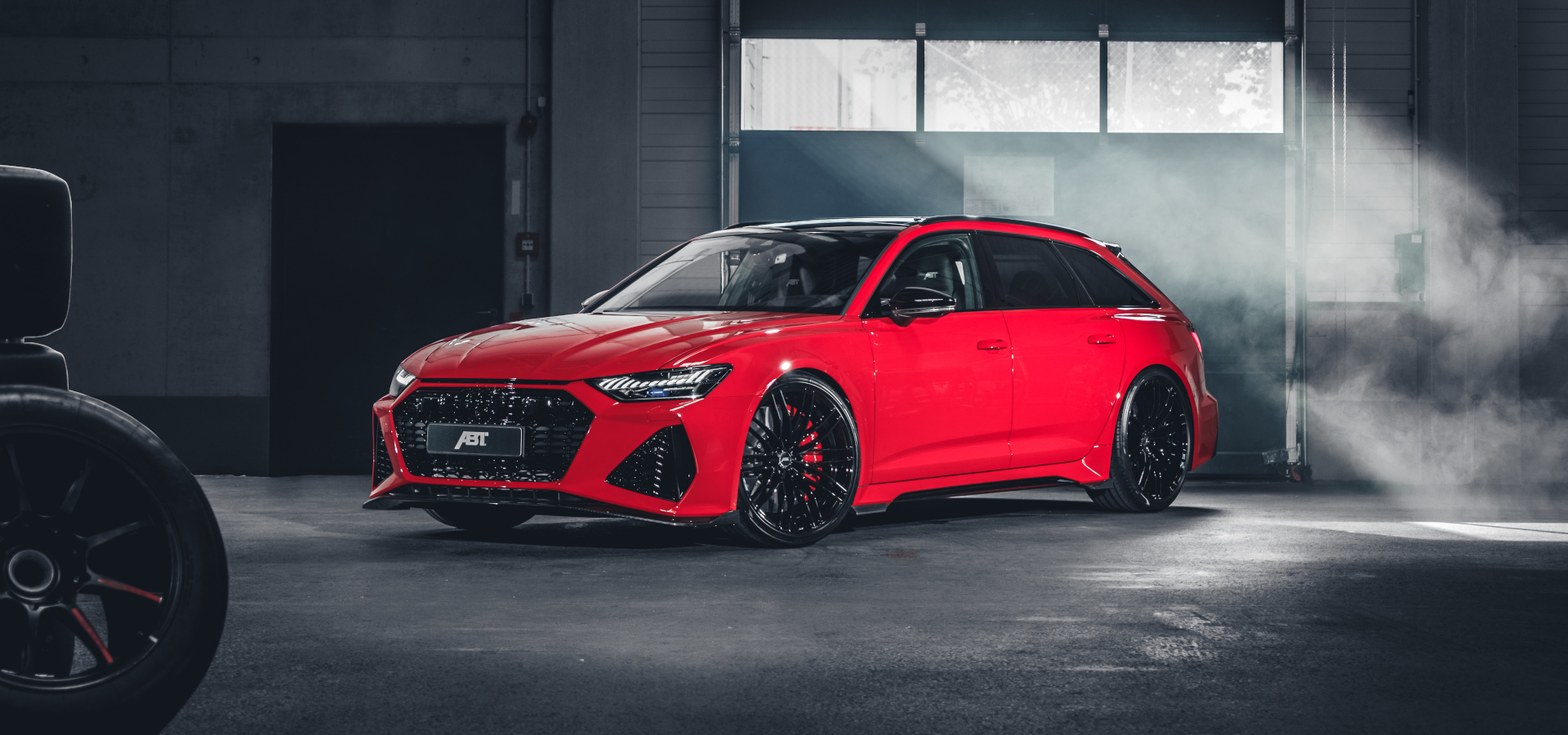 Red RS6-S from the side front view in the hall in front of the garage door 