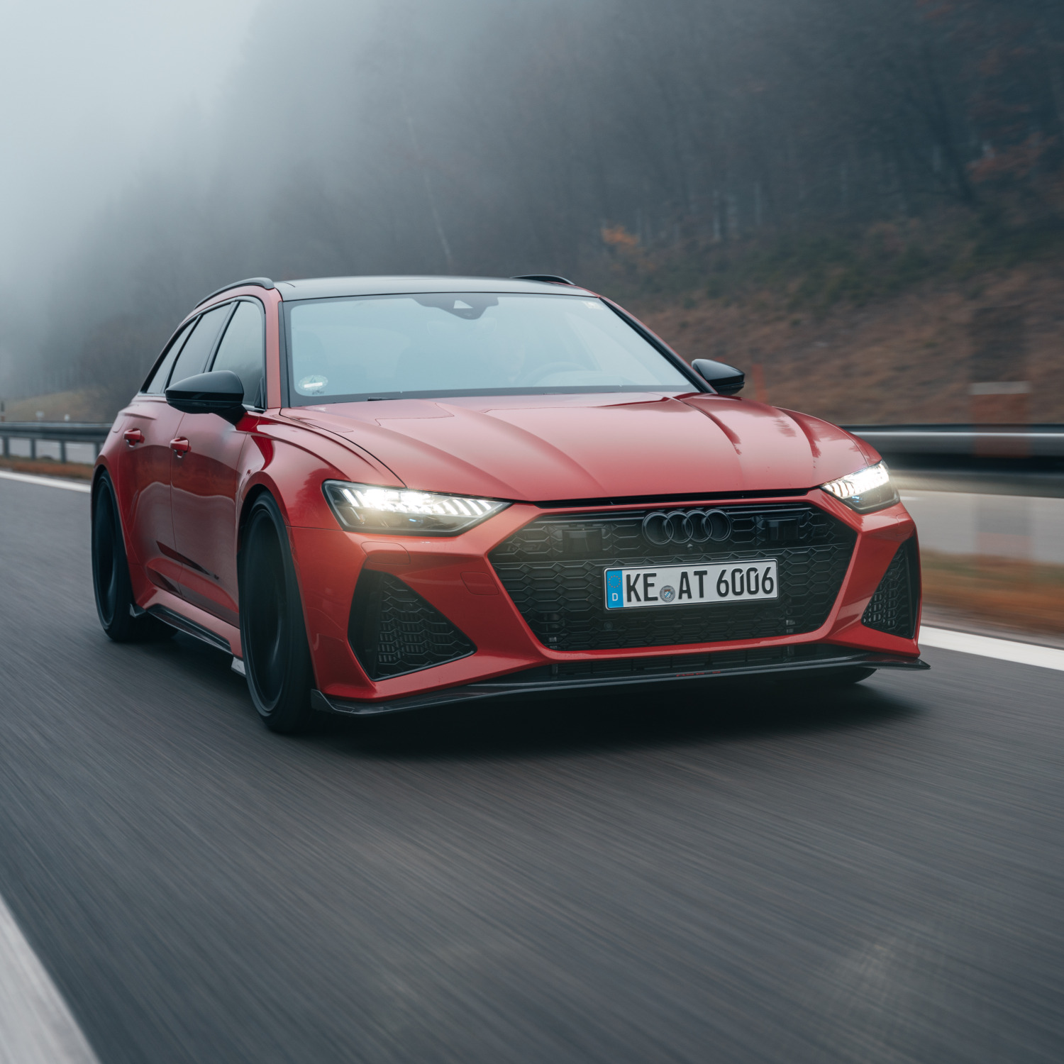 red RS6-S from the side front view while driving