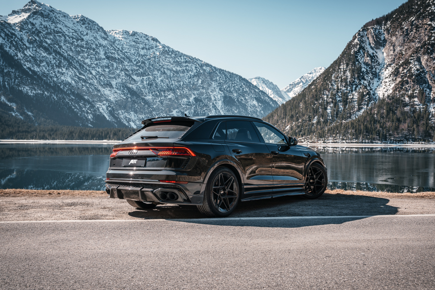 Black RSQ8 Signature Edition rear view in front of lake with mountain panorama