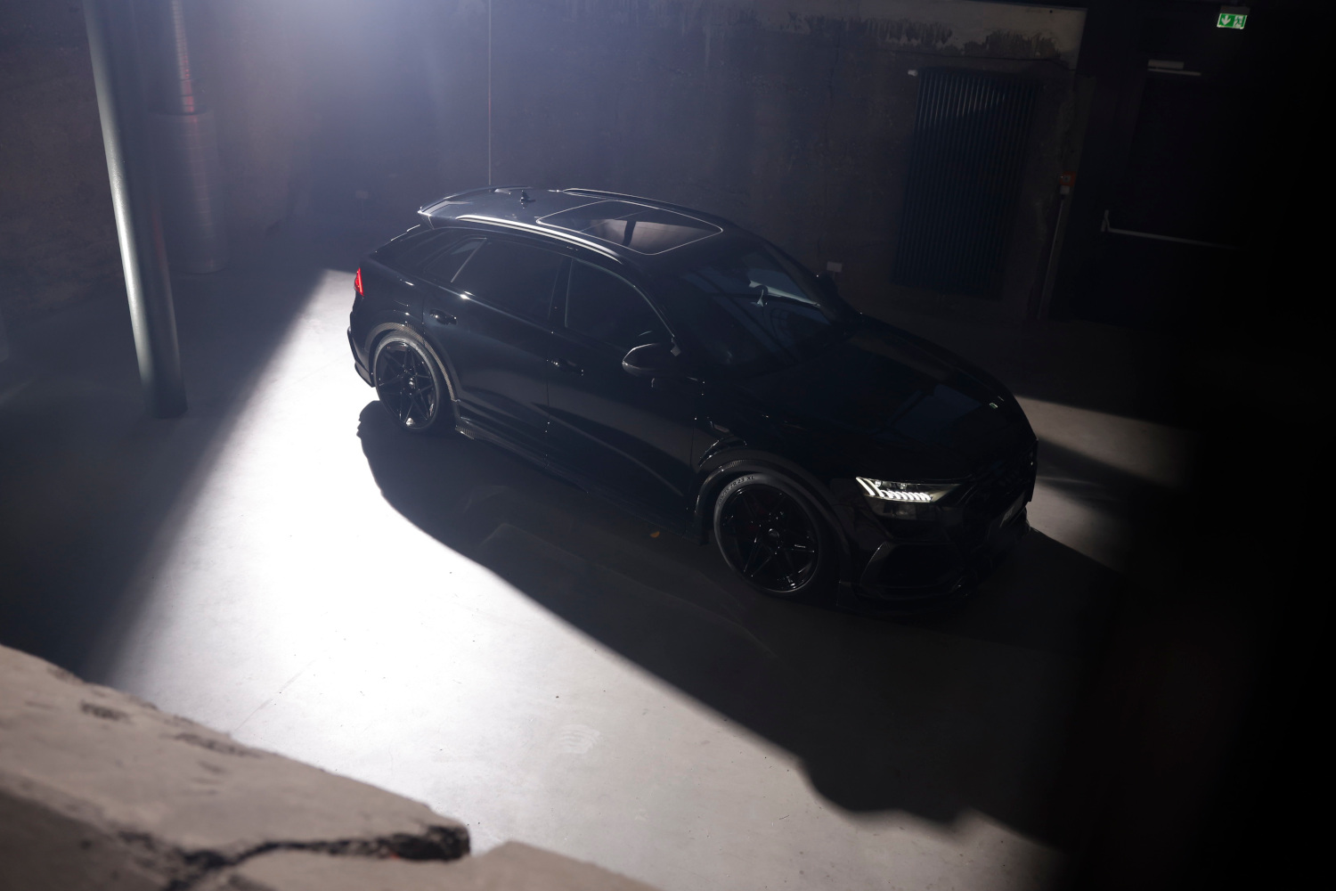 Black RSQ8 Signature Edition from a bird's eye view in a dark hall